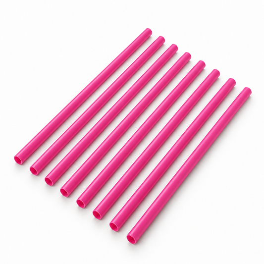 Eight pink cellulose drinking straws in a diagonal row on a white background